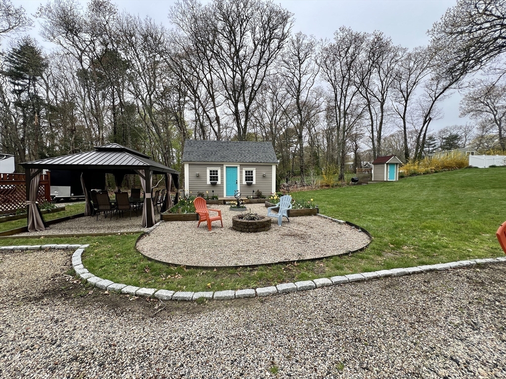 2045 Main Street Barnstable, MA 02648 - Photo 33 of 41 a view of a house with backyard and trees