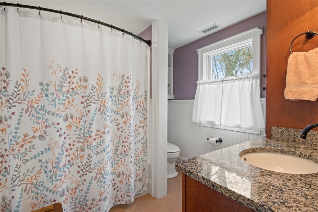 2045 Main Street Barnstable, MA 02648 - Photo 7 of 41 a bathroom with a granite countertop sink and a mirror