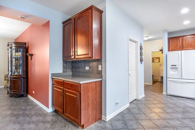 a kitchen with stainless steel appliances granite countertop a refrigerator and a stove