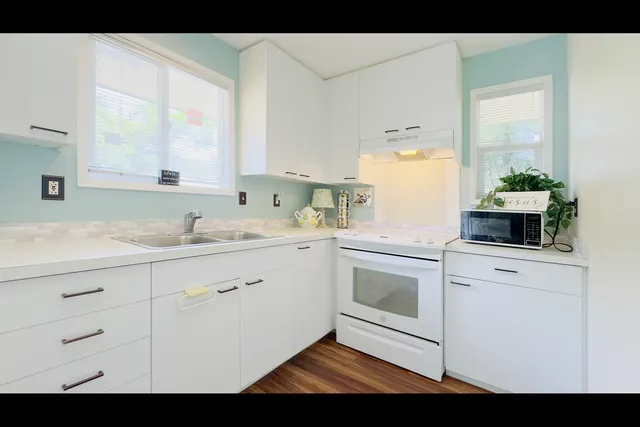 a utility room with cabinets washer and dryer
