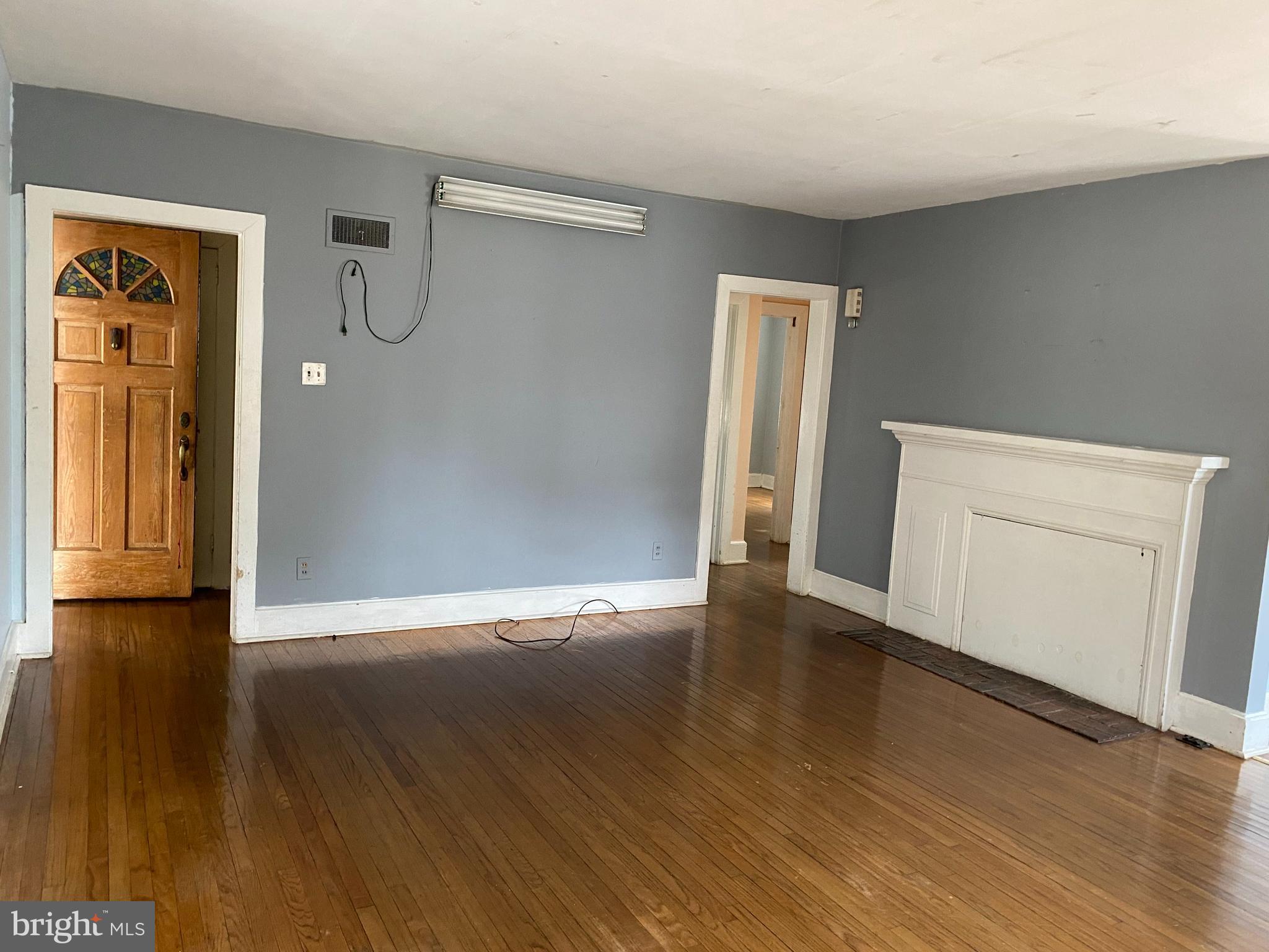 704 Bridgeboro Street Riverside, NJ 08075 - Photo 1 of 13 a view of an empty room with wooden floor and a window