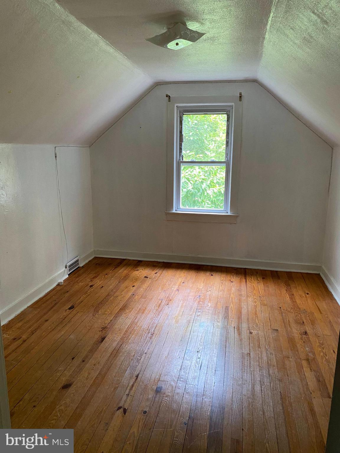 704 Bridgeboro Street Riverside, NJ 08075 - Photo 11 of 13 an empty room with wooden floor and windows