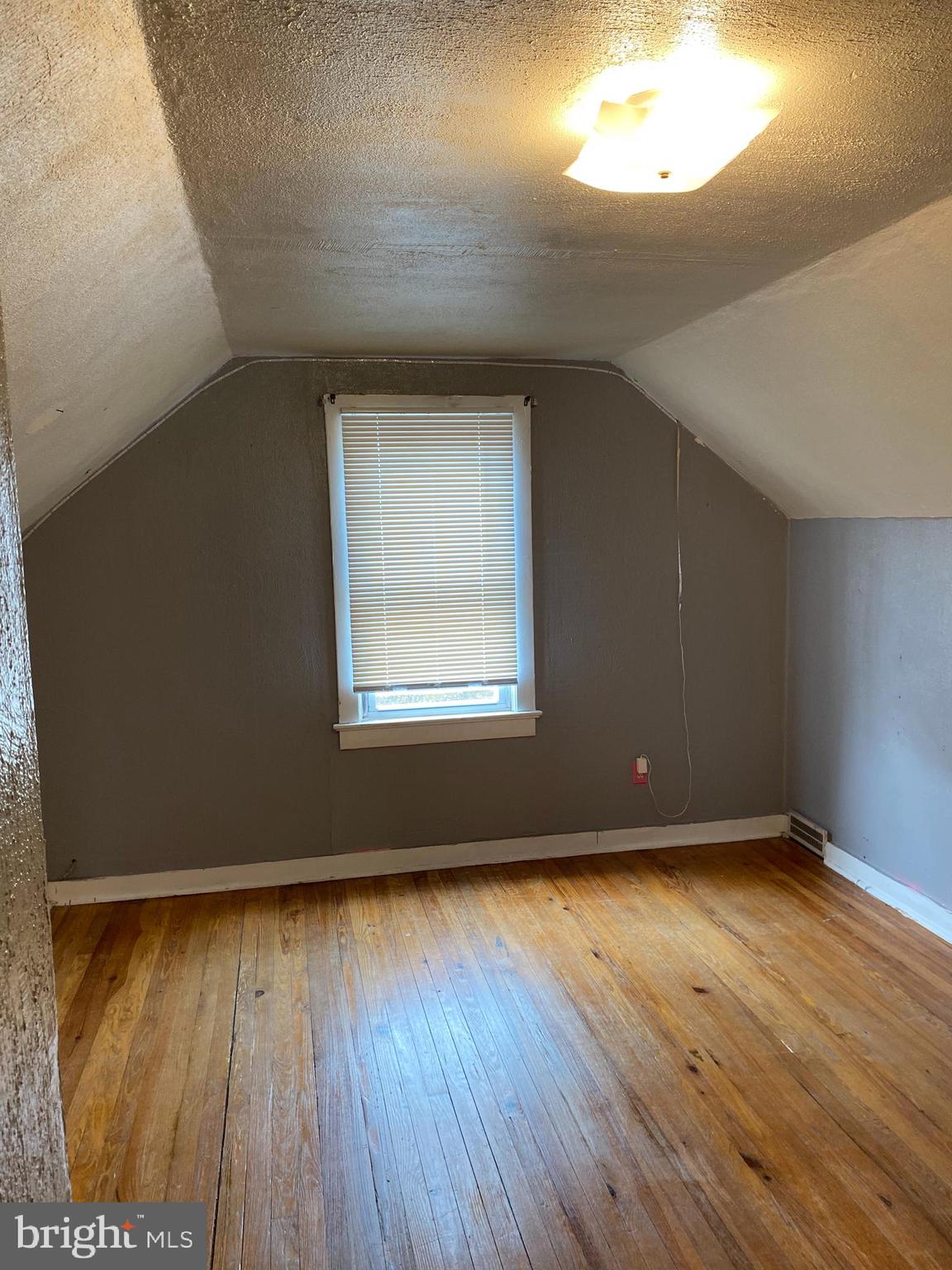 704 Bridgeboro Street Riverside, NJ 08075 - Photo 12 of 13 an empty room with wooden floor and windows
