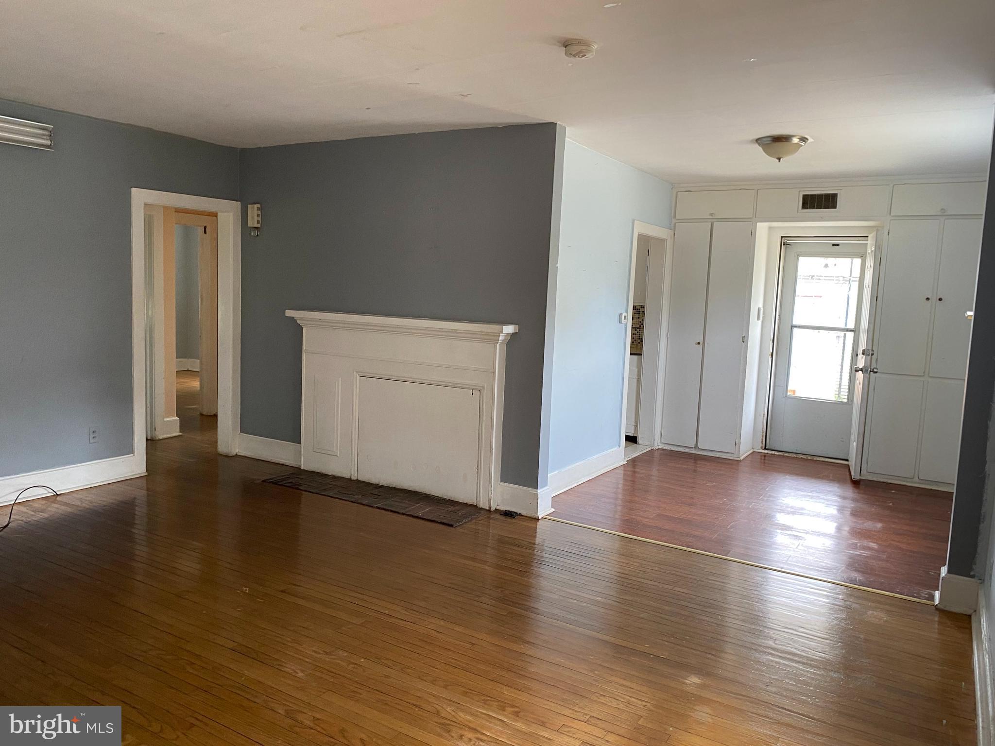 704 Bridgeboro Street Riverside, NJ 08075 - Photo 2 of 13 an empty room with wooden floor and windows