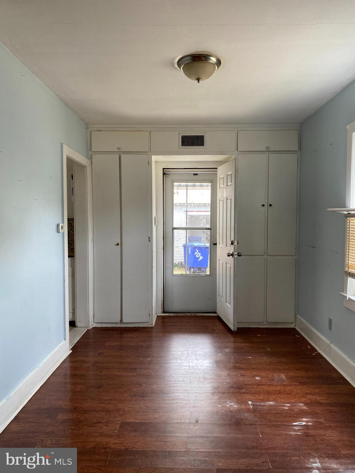 704 Bridgeboro Street Riverside, NJ 08075 - Photo 4 of 13 an empty room with wooden floor and windows