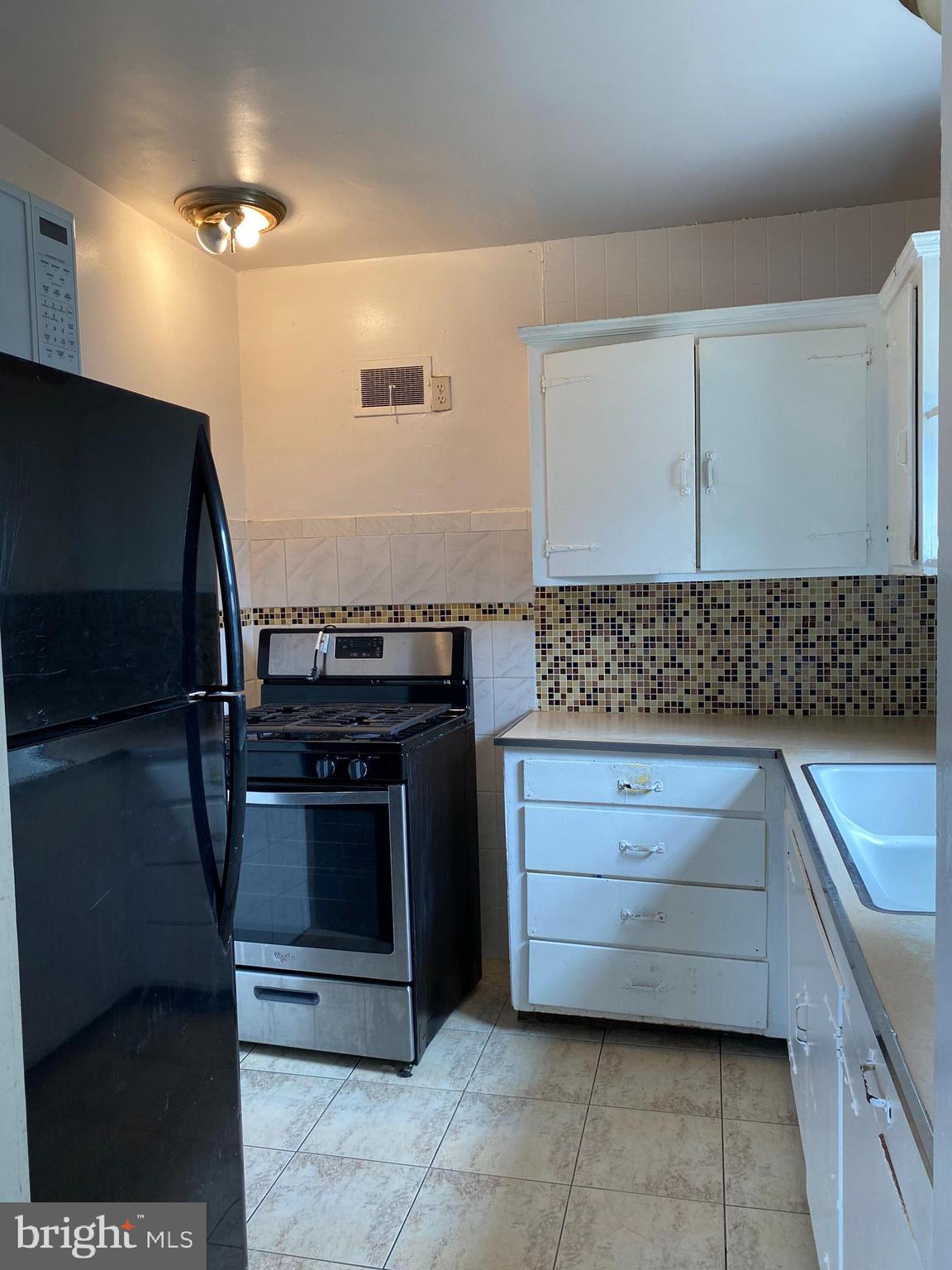 704 Bridgeboro Street Riverside, NJ 08075 - Photo 6 of 13 a kitchen with stainless steel appliances granite countertop a stove and a sink