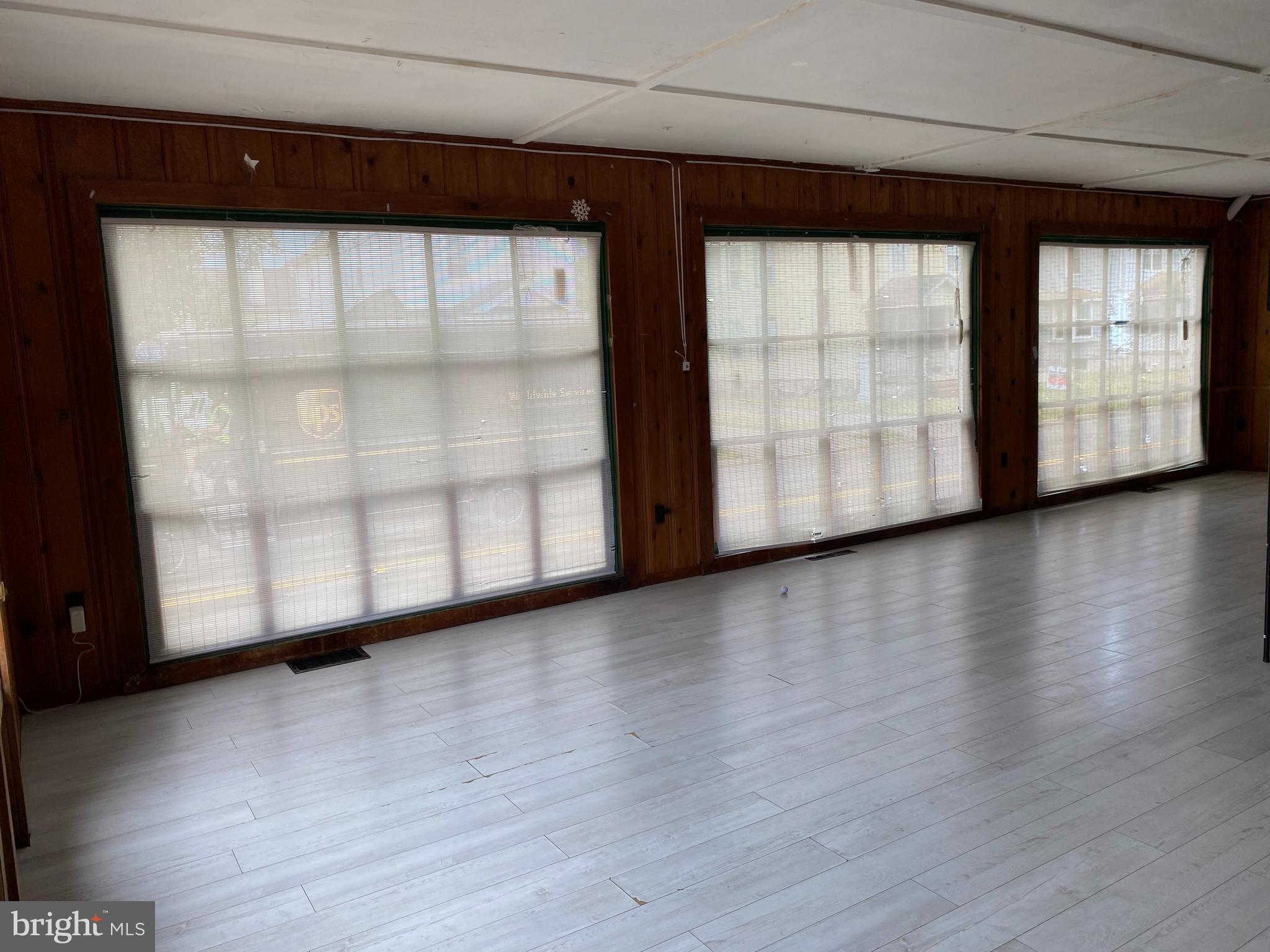 704 Bridgeboro Street Riverside, NJ 08075 - Photo 7 of 13 a view of an empty room with wooden floor and a window