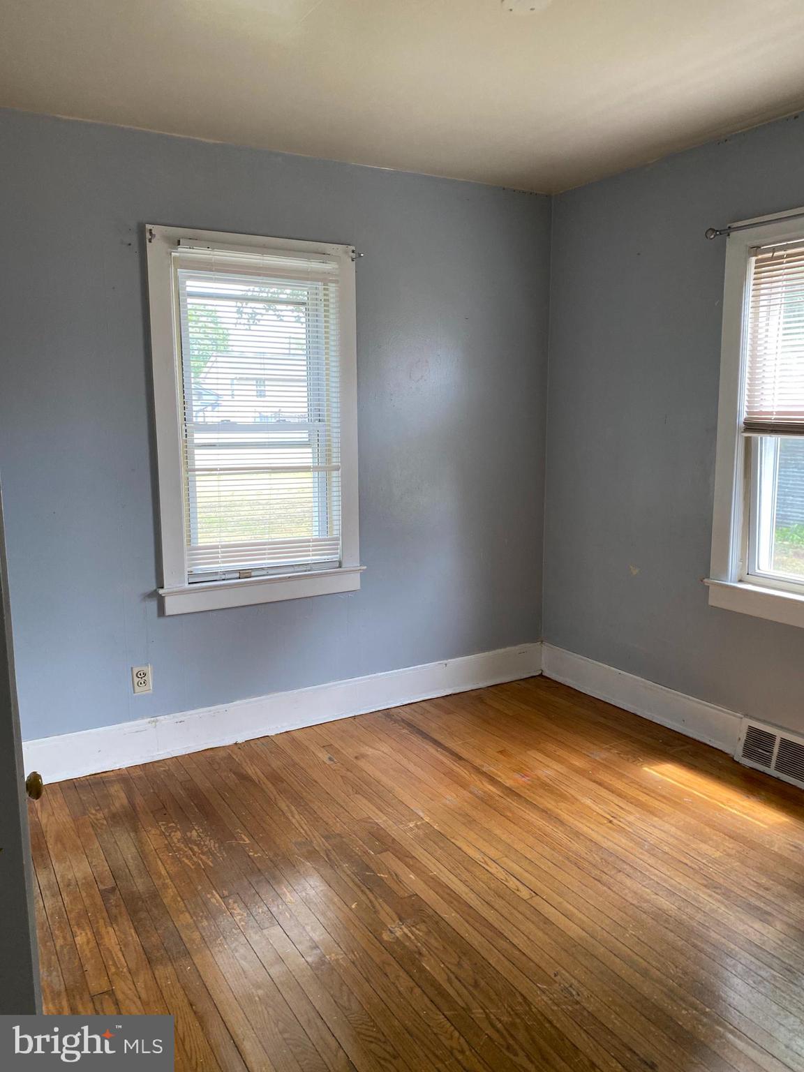 704 Bridgeboro Street Riverside, NJ 08075 - Photo 9 of 13 a view of an empty room with wooden floor and a window