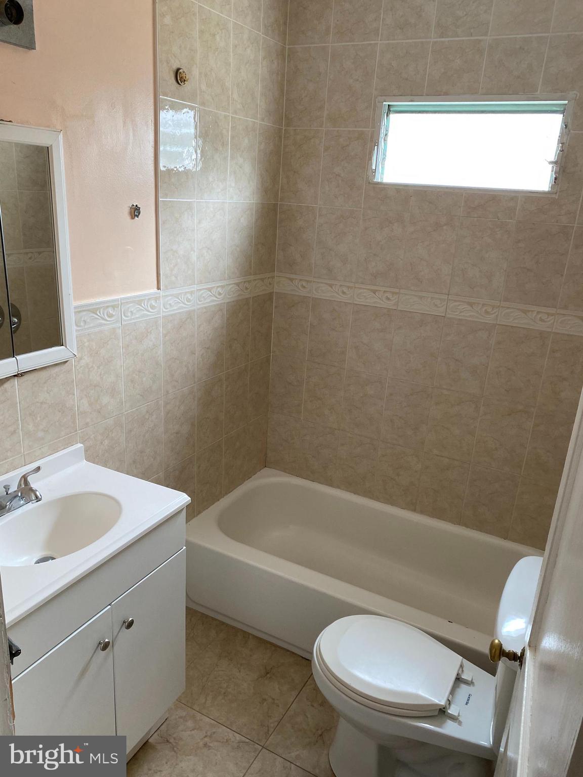 704 Bridgeboro Street Riverside, NJ 08075 - Photo 10 of 13 a bathroom with a sink a toilet and bathtub