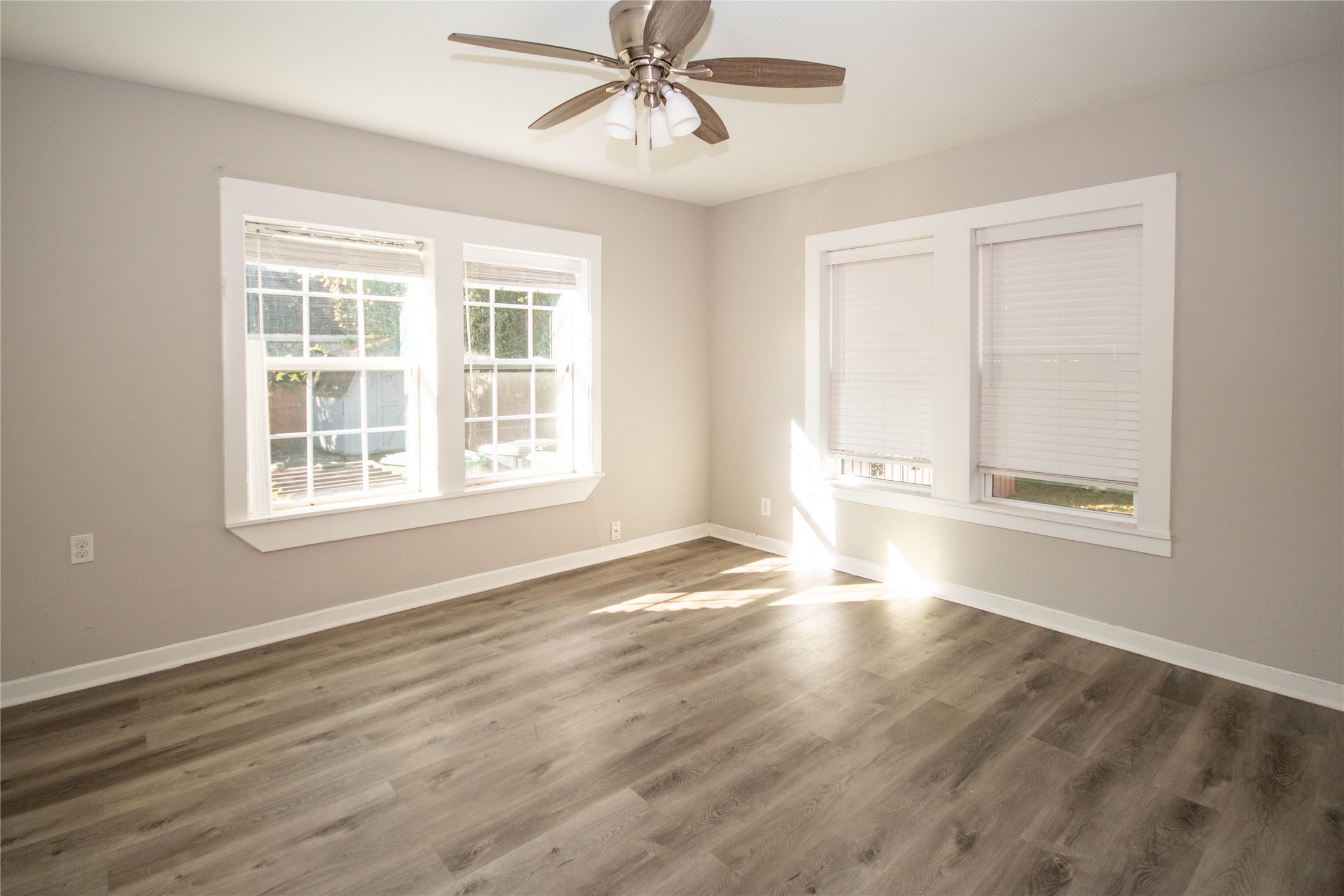 3412 Rosedale Street Houston, TX 77004 - Photo 12 of 26 a view of an empty room with wooden floor and a window
