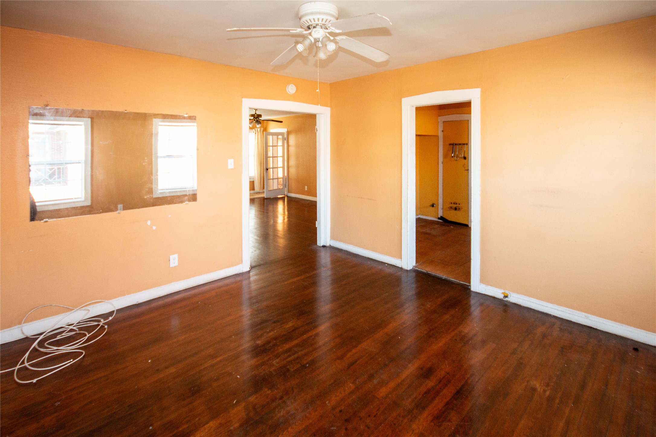 3412 Rosedale Street Houston, TX 77004 - Photo 17 of 26 a view of an empty room with wooden floor and a window