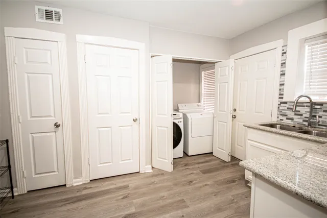 a view of a kitchen with a sink washer and dryer