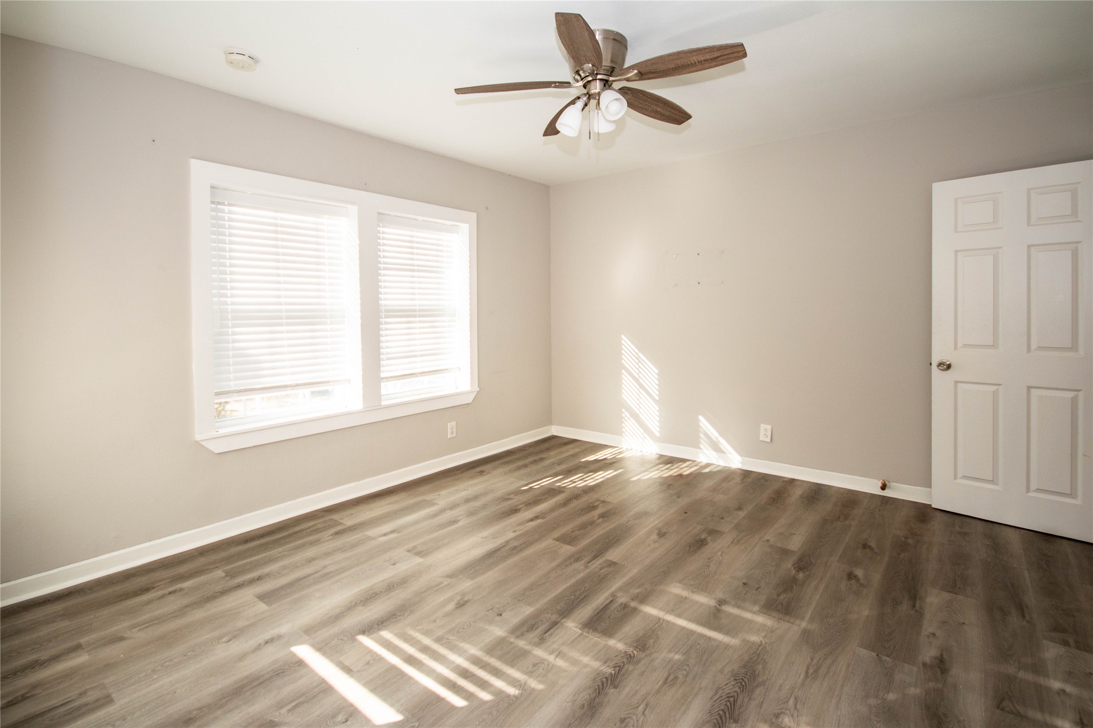 3412 Rosedale Street Houston, TX 77004 - Photo 10 of 26 a view of empty room with wooden floor and fan