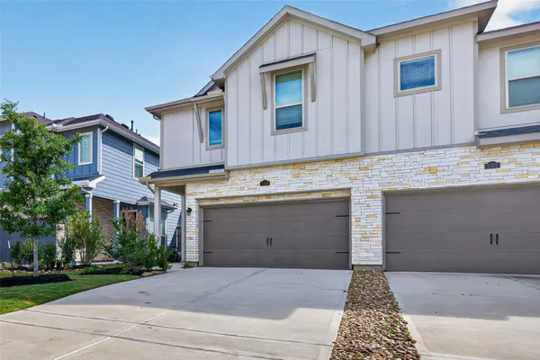 a view of an house with backyard and sitting area