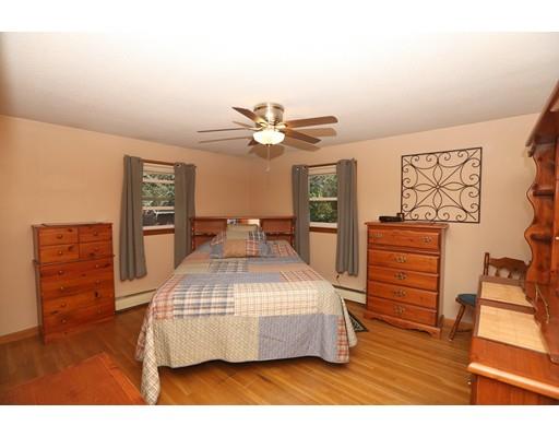 18 Rita Street Lowell, MA 01854 - Photo 8 of 14 a bedroom with a bed and dresser with wooden floor