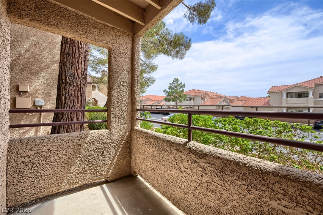 9325 West Desert Inn Road, Unit 177 Las Vegas, NV 89117 - Photo 11 of 24 A private balcony offers neighborhood views and tranquil moments amidst lush greenery.