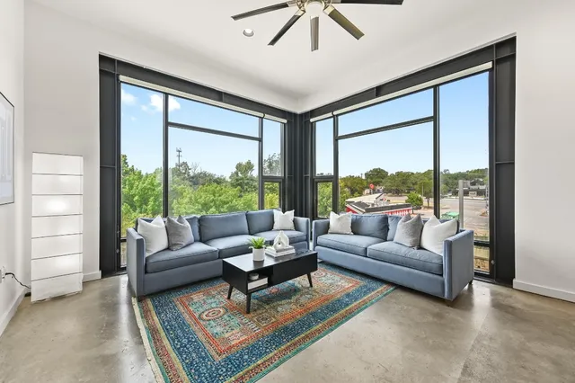 a living room with furniture and a large window