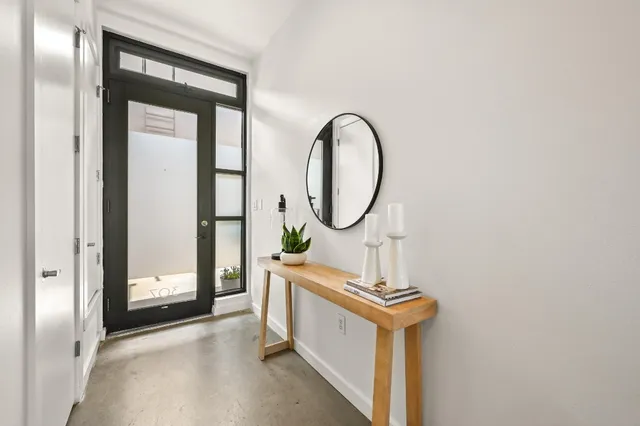 a view of a hallway with entryway front door