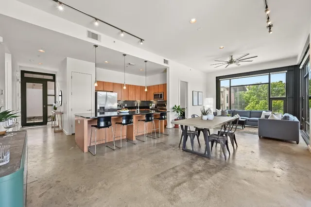 a large kitchen with a table and chairs