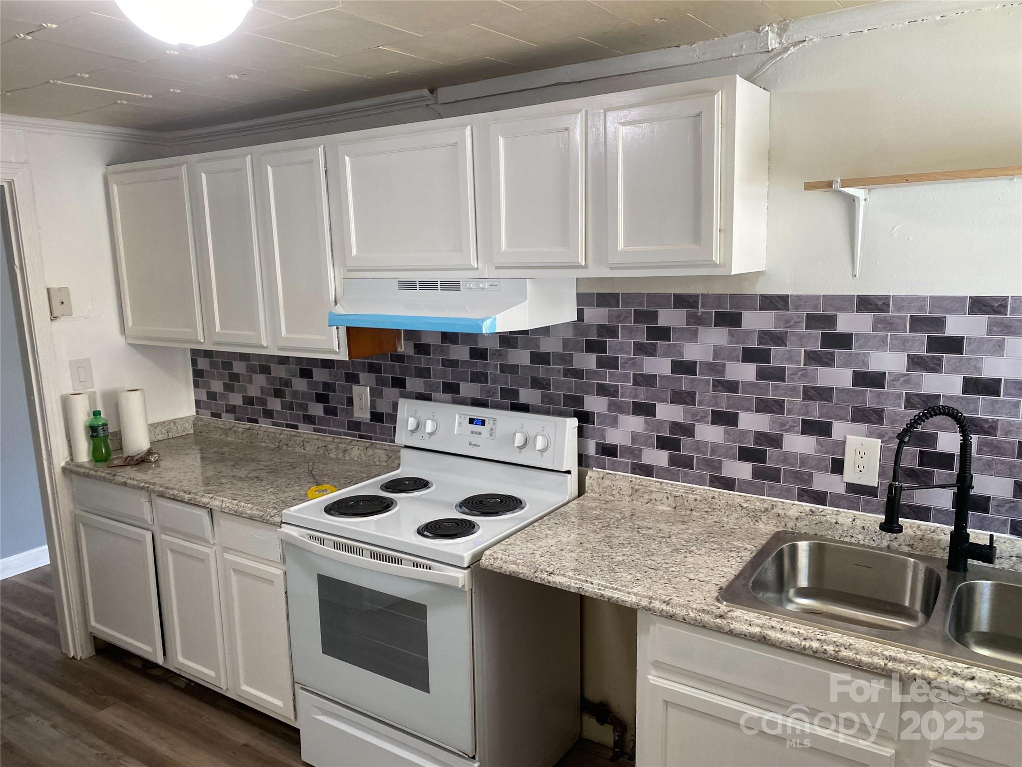 1345 Standish Street, Unit A Salisbury, NC 28144 - Photo 15 of 16 a kitchen with granite countertop a sink stove and cabinets