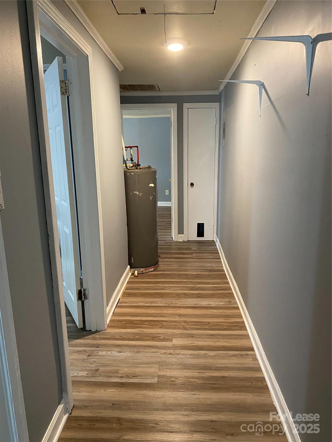 1345 Standish Street, Unit A Salisbury, NC 28144 - Photo 16 of 16 a view of a hallway with wooden floor and staircase