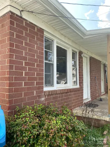 a view of a brick house with a large window