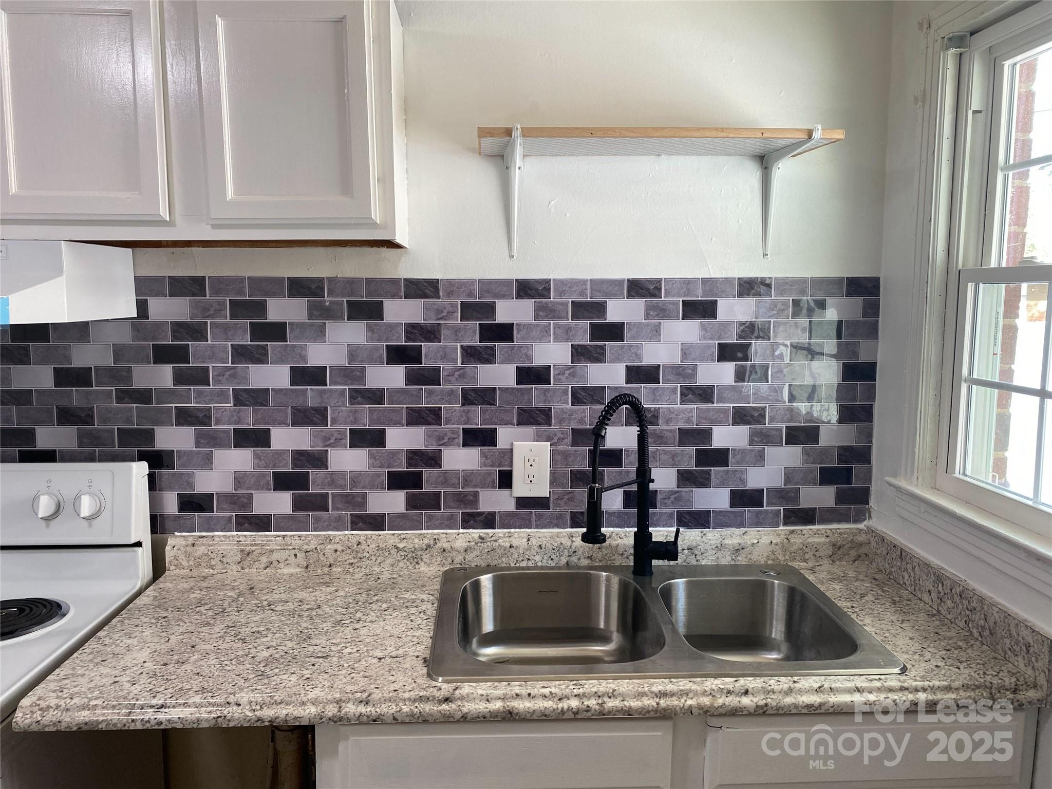 1345 Standish Street, Unit A Salisbury, NC 28144 - Photo 3 of 16 a kitchen with granite countertop a sink and a stove