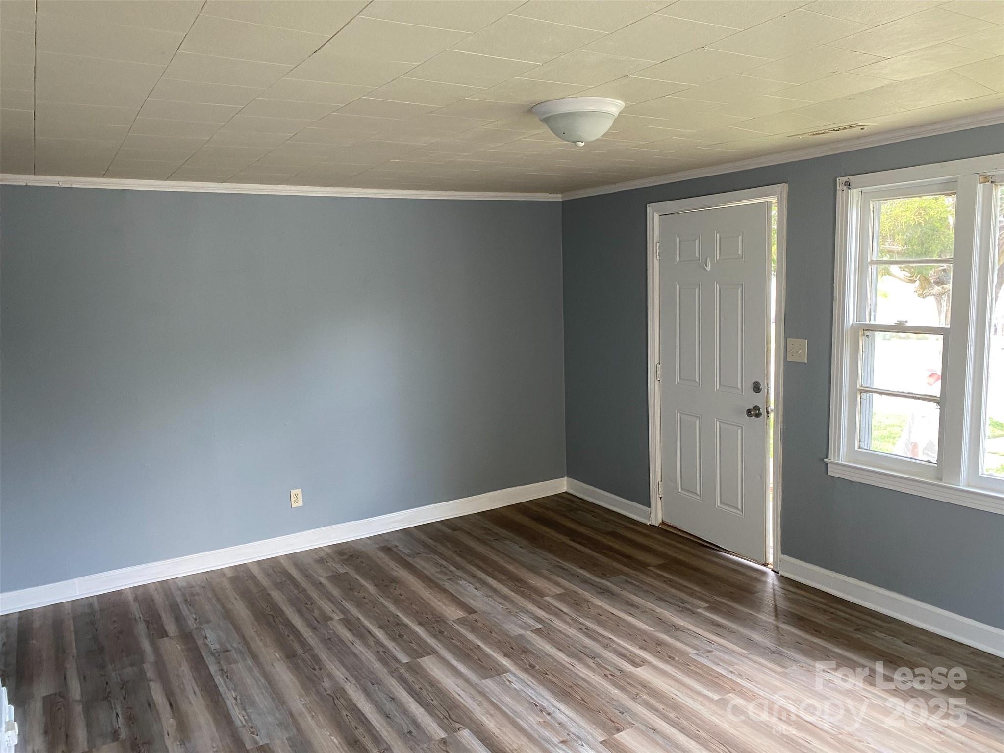 1345 Standish Street, Unit A Salisbury, NC 28144 - Photo 8 of 16 a view of an empty room with wooden floor and a window