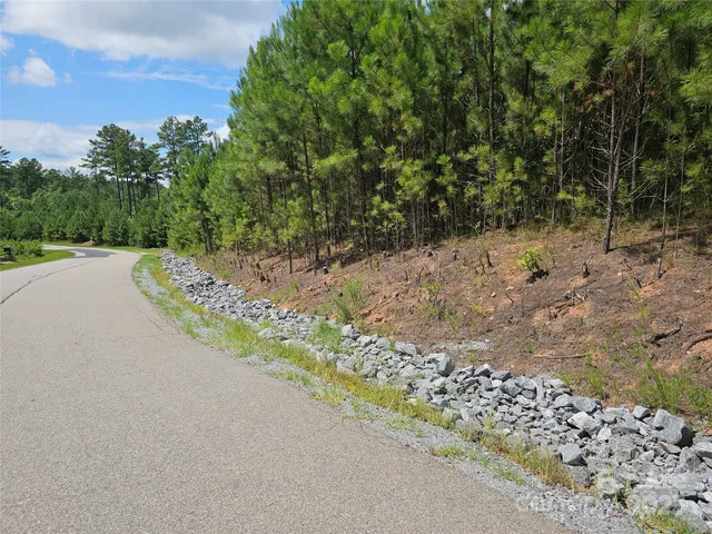 a view of a patio with a table and chairs under an umbrella