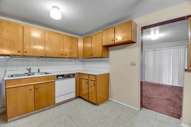 a kitchen with a sink and cabinets