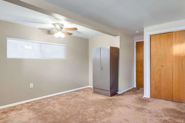 a view of a livingroom with a chandelier fan