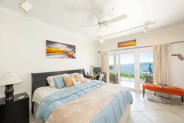 a bedroom with furniture and a large window