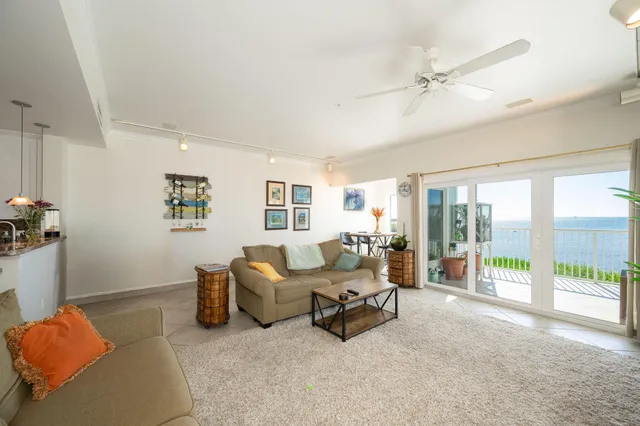 a living room with furniture and a floor to ceiling window