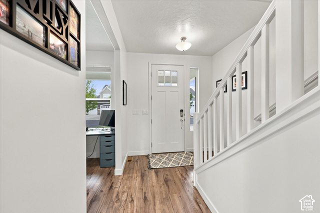 972 Vine Street Mapleton, UT 84664 - Photo 3 of 40 Wood-finish flooring, white painted staircase, and a front entry door with glass paneling
