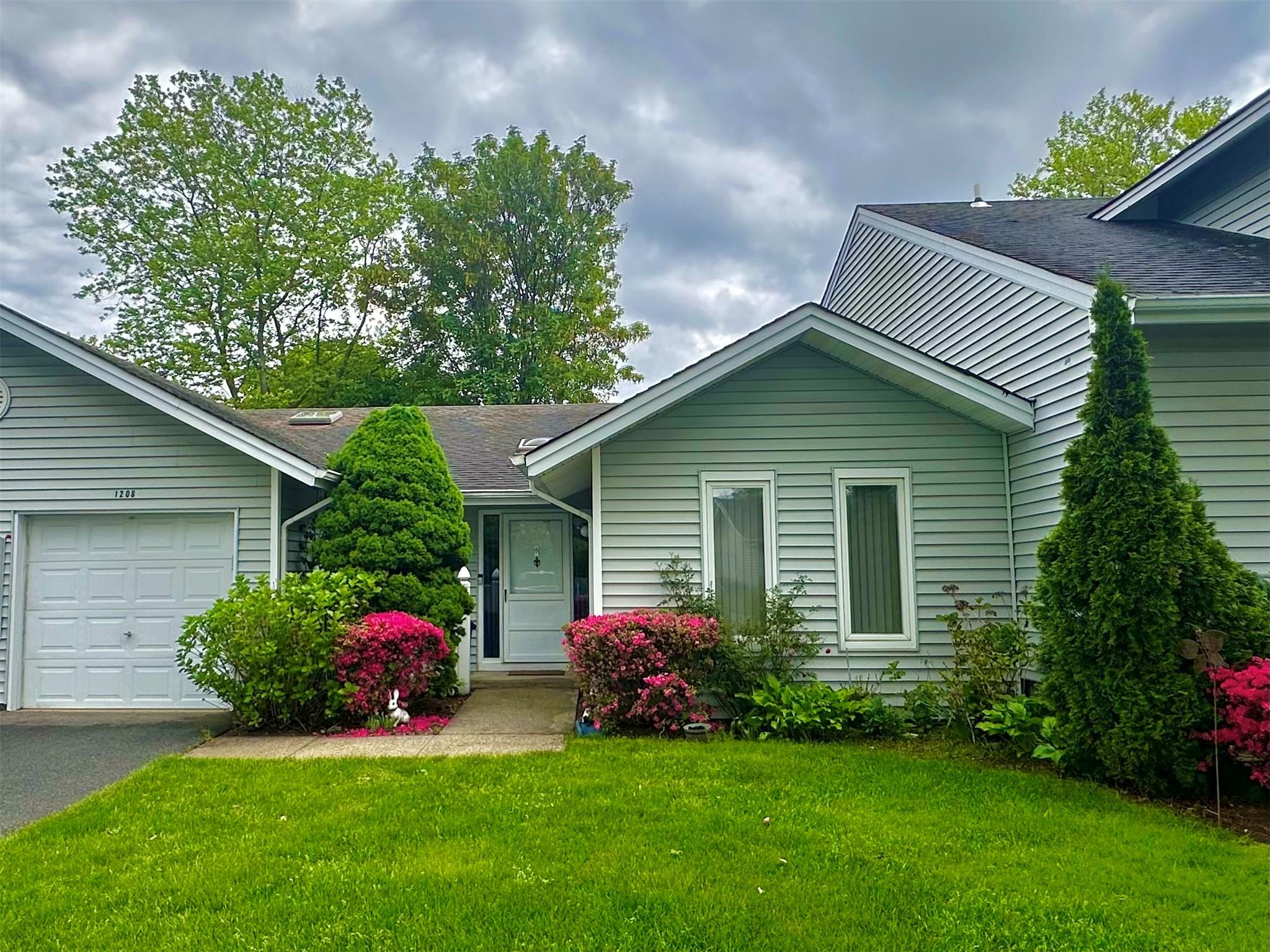 1208 Fenway Road St. James, NY 11780 - Photo 1 of 1 Ranch-style home with a front yard, a garage, a shingled roof, and driveway