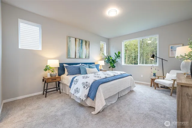 a bedroom with a bed potted plant and a window