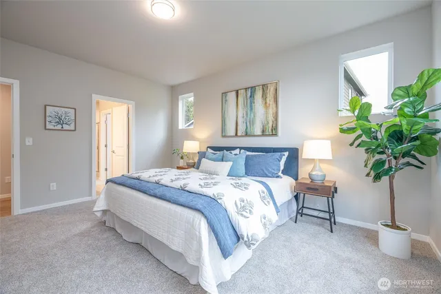 a bed sitting in a bedroom next to a window