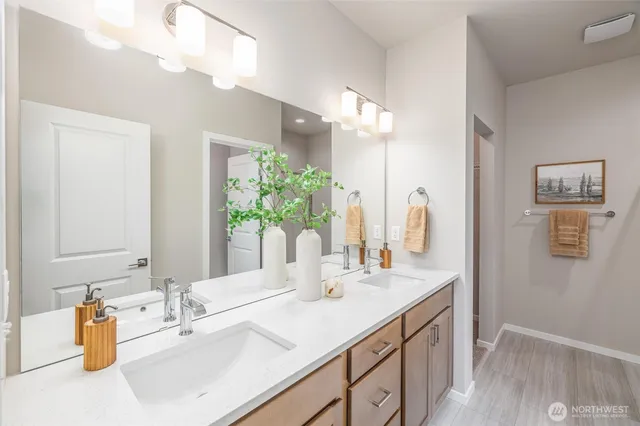 a bathroom with a granite countertop sink a toilet and a mirror