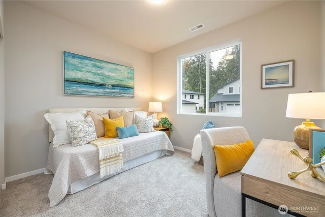 a bedroom with a bed and a lamp