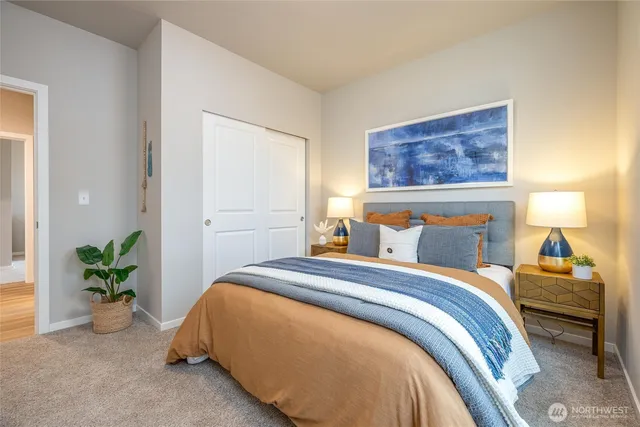 a bedroom with a bed and a lamp