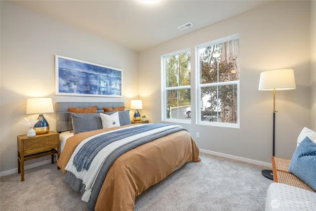 a bedroom with a bed and a large window