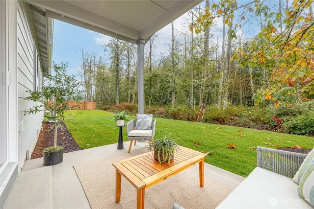 a view of a house with backyard and sitting area