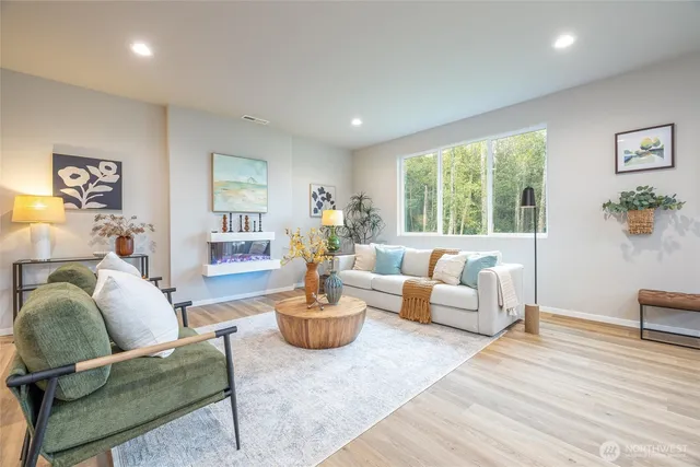 a living room with furniture and a wooden floor
