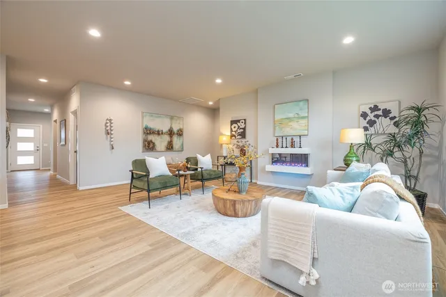 a kitchen with stainless steel appliances kitchen island granite countertop a stove a sink a microwave a dining table and chairs