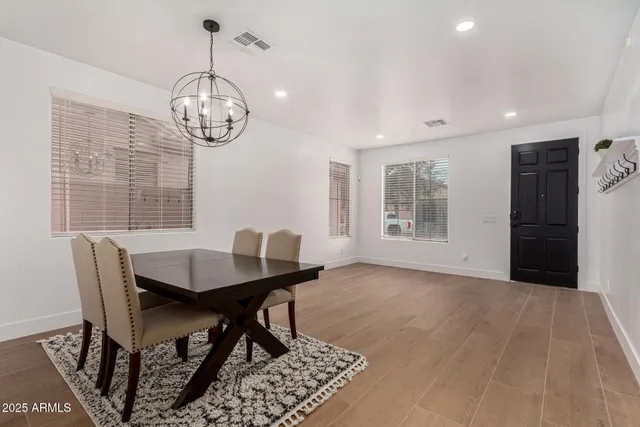 a view of a dining room with furniture wooden floor and chandelier
