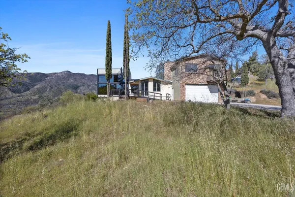 a kitchen with stainless steel appliances granite countertop a stove a sink dishwasher and white cabinets with wooden floor