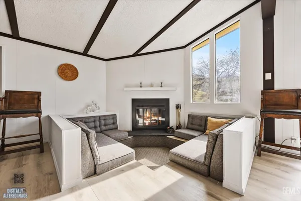 a kitchen with stainless steel appliances granite countertop a sink a stove and white cabinets with wooden floor