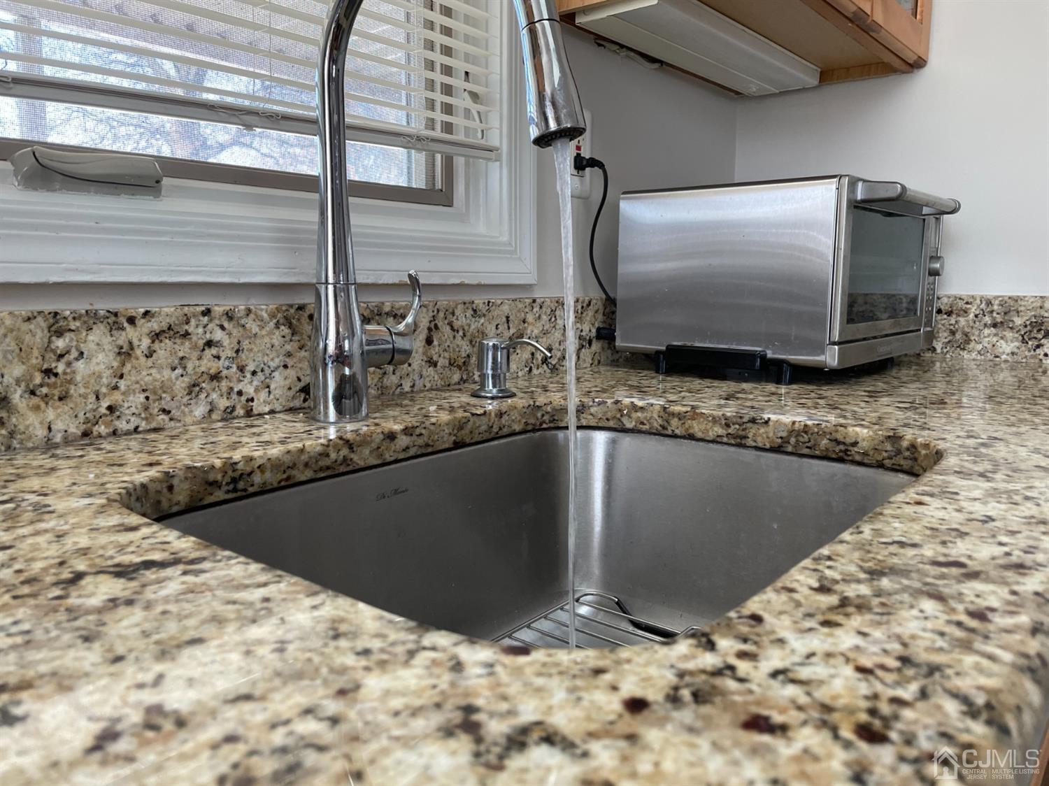 43 Brookville Road Edison, NJ 08817 - Photo 3 of 31 a bathroom with a granite countertop sink and a mirror