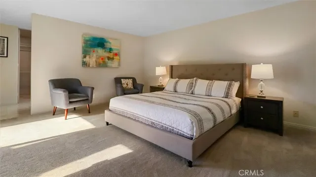 a bedroom with a bed and a chair