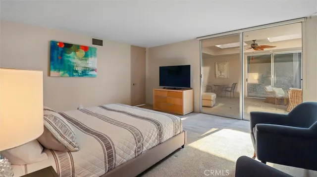 a bedroom with a bed and a television